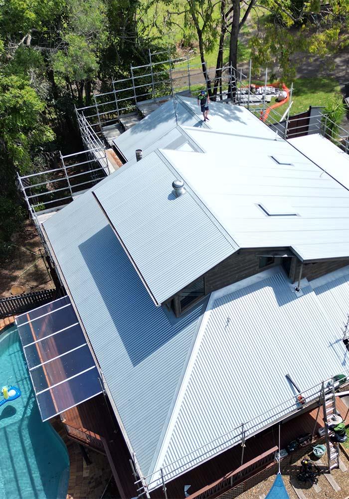 roofers standing on roof with scaffolding